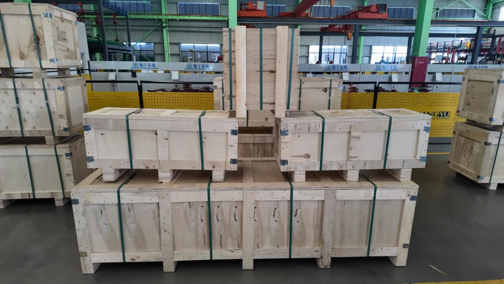 Close view of wooden crates secured with green strapping for the Kenya CYA pump shipment.