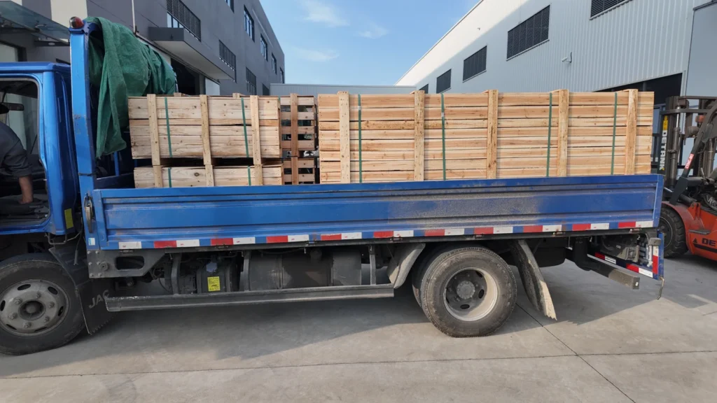 Wooden crates loaded on a blue truck for the UHB slurry pump shipment to Morocco.